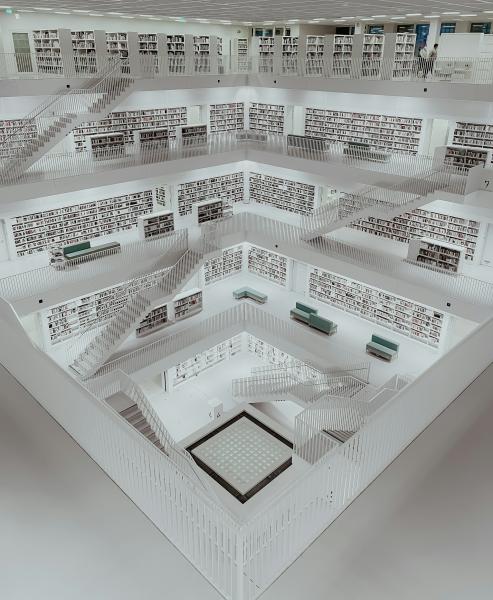A room filled with lots of shelves. Each floor is filled with books