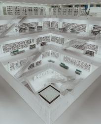 A room filled with lots of shelves. Each floor is filled with books